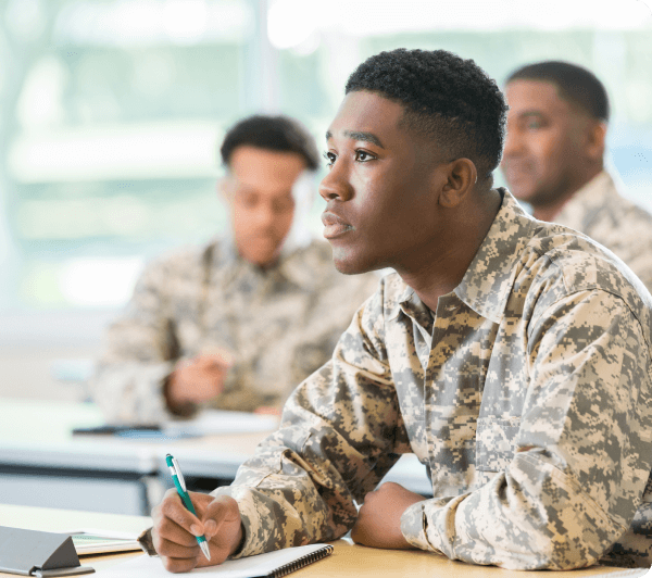 military member taking notes in class